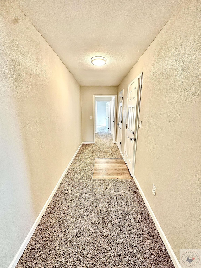 corridor featuring a textured ceiling