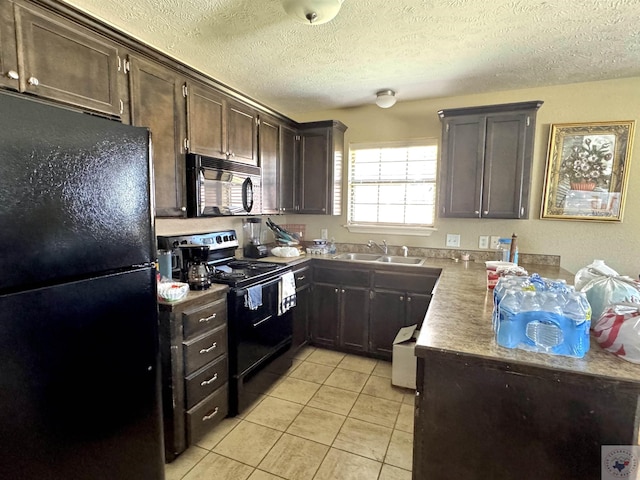 kitchen featuring black appliances, a textured ceiling, light tile patterned floors, sink, and dark brown cabinetry