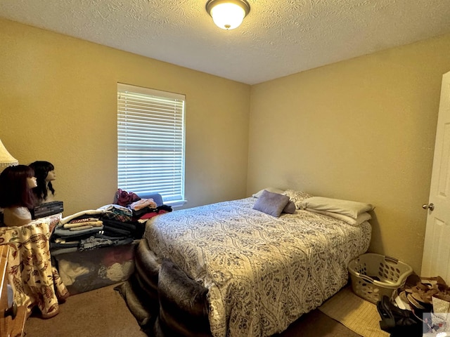 carpeted bedroom featuring a textured ceiling