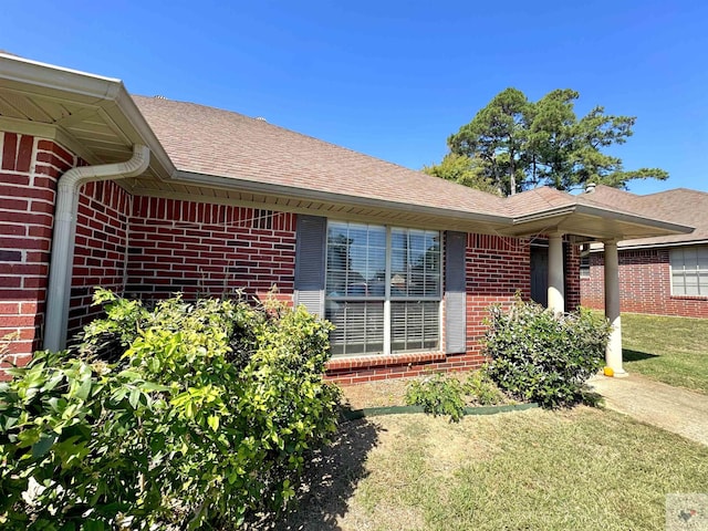 view of side of home featuring a yard