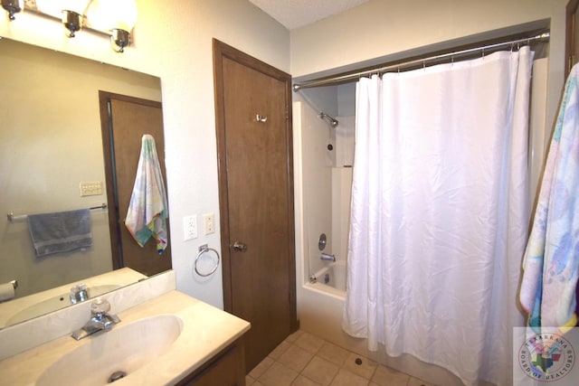 bathroom featuring vanity, tile patterned floors, a textured ceiling, and shower / tub combo with curtain