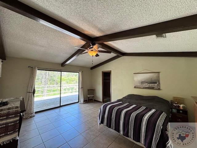 tiled bedroom with access to exterior, ceiling fan, vaulted ceiling with beams, and a textured ceiling