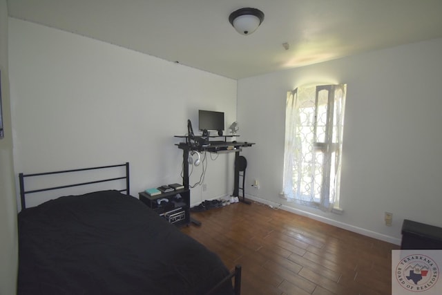 bedroom featuring dark hardwood / wood-style floors and multiple windows