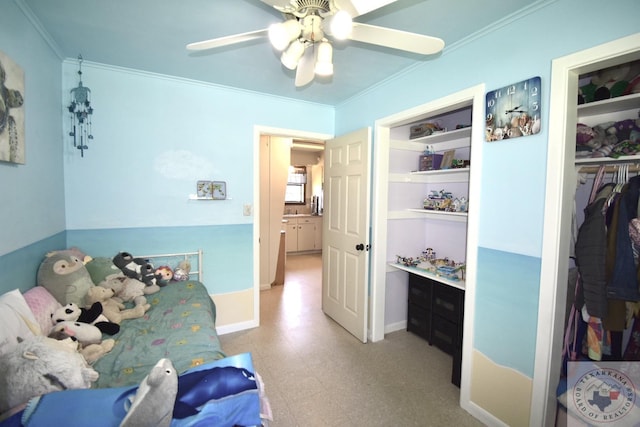 bedroom featuring a closet, ceiling fan, and crown molding