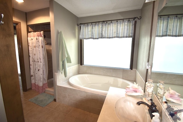 bathroom with vanity, tile patterned floors, separate shower and tub, and a textured ceiling