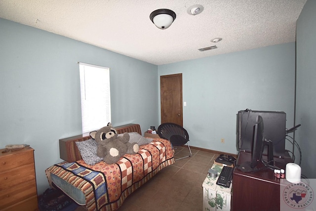 bedroom featuring a textured ceiling