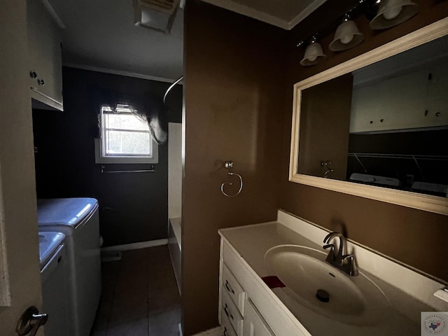 full bathroom with tile patterned flooring, washer and dryer, toilet, vanity, and ornamental molding