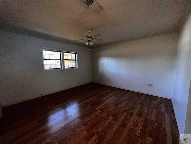 unfurnished room featuring dark hardwood / wood-style floors and ceiling fan