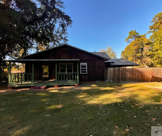 back of property with a lawn