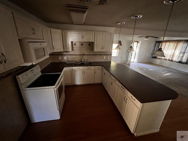 kitchen featuring pendant lighting, white appliances, white cabinetry, sink, and kitchen peninsula