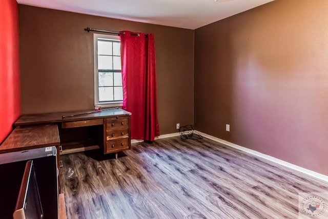 unfurnished office featuring hardwood / wood-style flooring