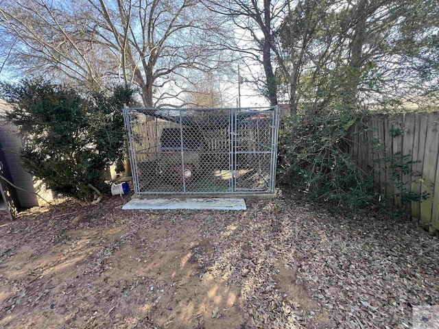 view of gate with an outbuilding