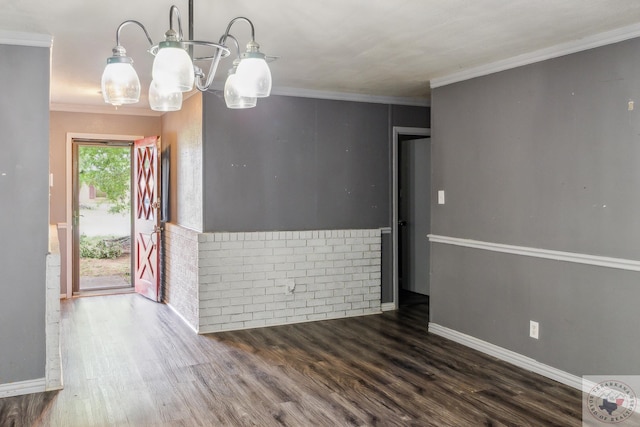 spare room with ornamental molding and dark hardwood / wood-style floors