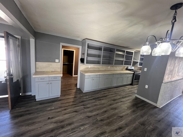 kitchen with pendant lighting, dark hardwood / wood-style flooring, stainless steel range with gas stovetop, and gray cabinets