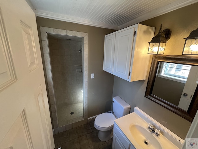 bathroom featuring tile patterned flooring, vanity, tiled shower, and toilet