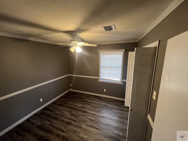 unfurnished bedroom featuring crown molding, ceiling fan, dark hardwood / wood-style floors, and a textured ceiling