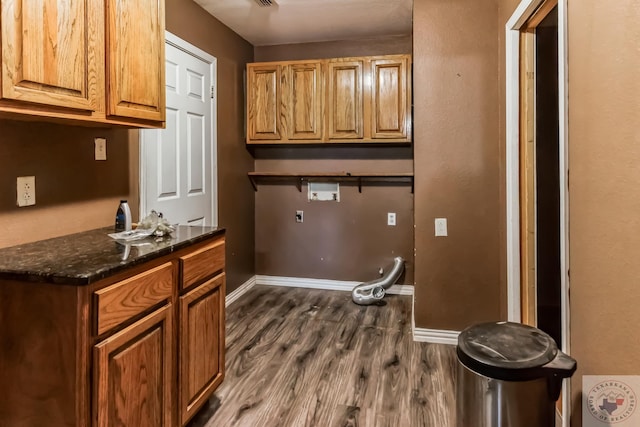 laundry area featuring cabinets, dark hardwood / wood-style floors, and washer hookup