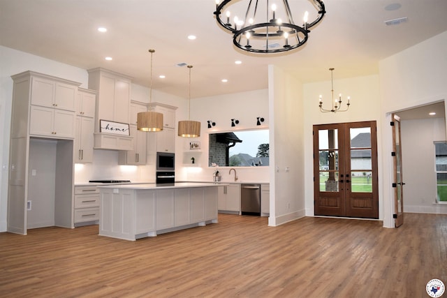 105 Bronco, Texarkana, TX 75503 - kitchen with a chandelier, stainless steel appliances, light wood-style floors, light countertops, and recessed lighting