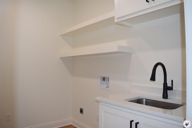 105 Bronco, Texarkana, TX 75503 - laundry room featuring hookup for a washing machine, electric dryer hookup, cabinet space, and baseboards