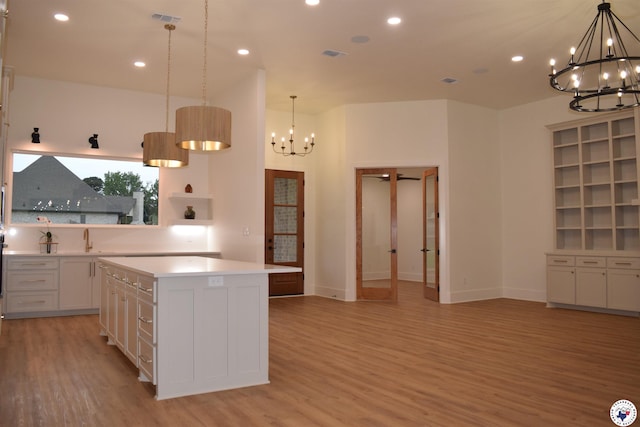 105 Bronco, Texarkana, TX 75503 - kitchen with a chandelier, light wood finished floors, light countertops, a kitchen island, and recessed lighting