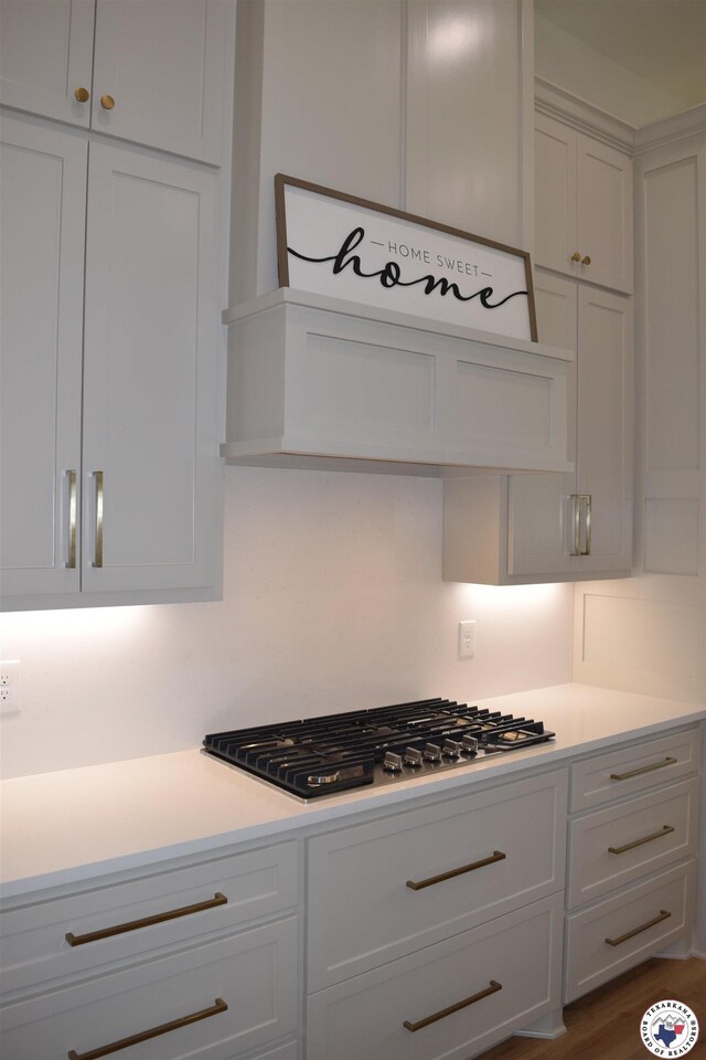 105 Bronco, Texarkana, TX 75503 - kitchen featuring stainless steel gas cooktop, light countertops, and white cabinetry