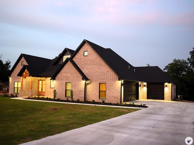105 Bronco, Texarkana, TX 75503 - view of front of house featuring a front lawn, concrete driveway, an attached garage, brick siding, and central air condition unit