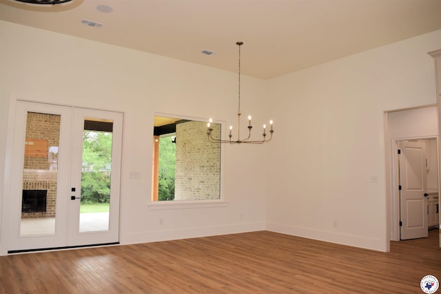 105 Bronco, Texarkana, TX 75503 - unfurnished dining area featuring wood finished floors, a chandelier, and baseboards