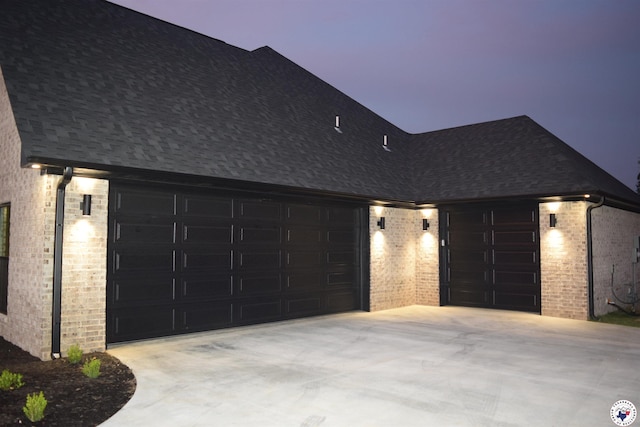 105 Bronco, Texarkana, TX 75503 - view of front of property featuring concrete driveway, brick siding, an attached garage, and roof with shingles