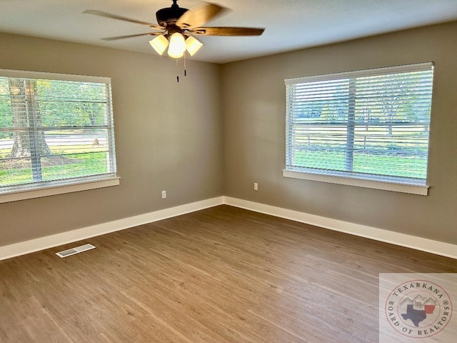 empty room featuring ceiling fan and hardwood / wood-style floors