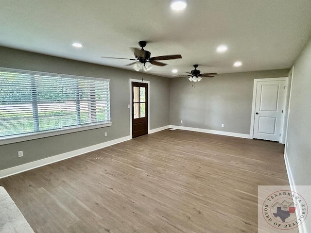 spare room with ceiling fan and hardwood / wood-style floors