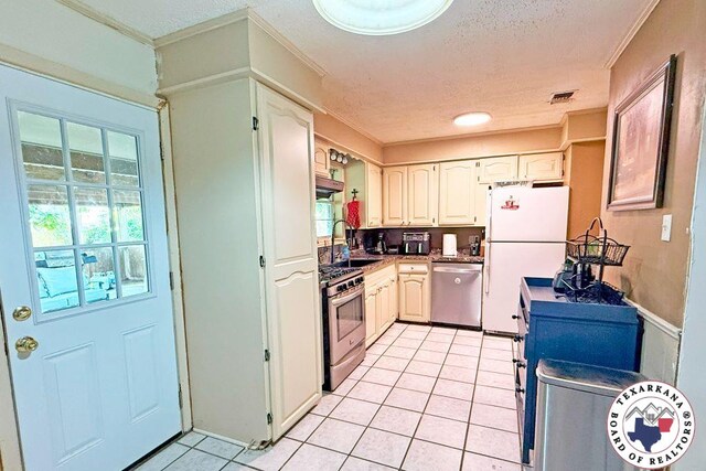5 Sidney Dr, Texarkana, TX 75503 - kitchen with appliances with stainless steel finishes, light tile patterned floors, crown molding, a sink, and a textured ceiling