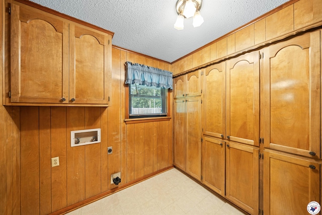 6514 Buchanan Loop, Texarkana, TX 75501 - washroom with cabinet space, electric dryer hookup, hookup for a washing machine, light flooring, and a textured ceiling