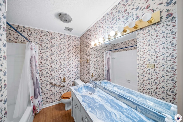 6514 Buchanan Loop, Texarkana, TX 75501 - full bathroom featuring crown molding, wallpapered walls, shower / tub combo with curtain, wood finished floors, and vanity
