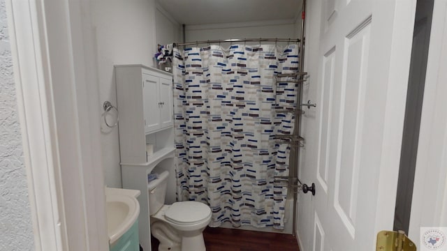 bathroom featuring sink, wood-type flooring, toilet, and walk in shower