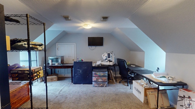 carpeted home office featuring lofted ceiling and a textured ceiling