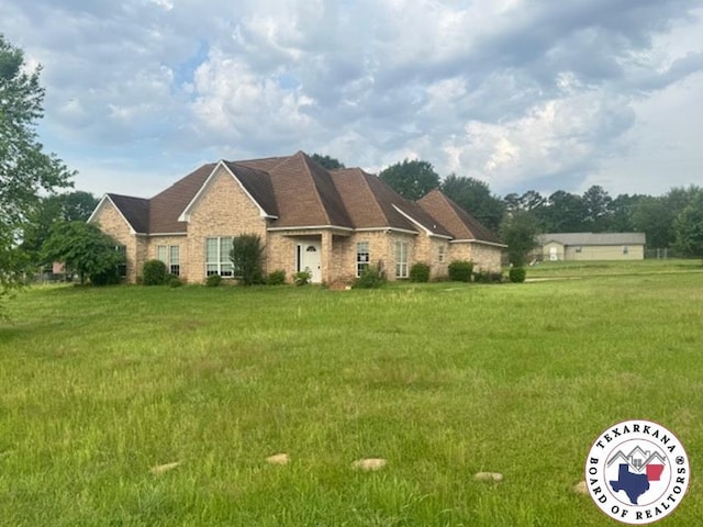 ranch-style home with a front lawn