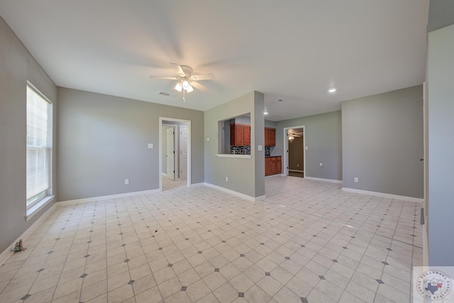 unfurnished living room with ceiling fan