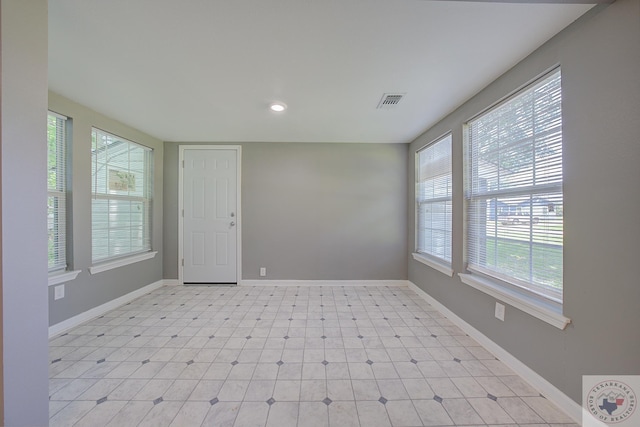 spare room featuring a healthy amount of sunlight