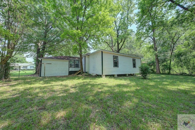 rear view of property featuring a yard