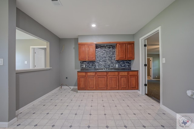 kitchen with sink and tasteful backsplash