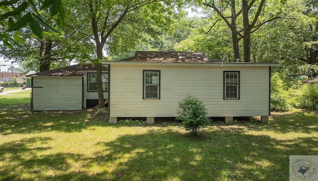 view of outdoor structure featuring a lawn