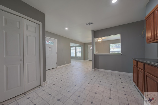 kitchen featuring ceiling fan and a wealth of natural light