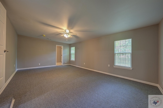 spare room featuring ceiling fan and carpet flooring