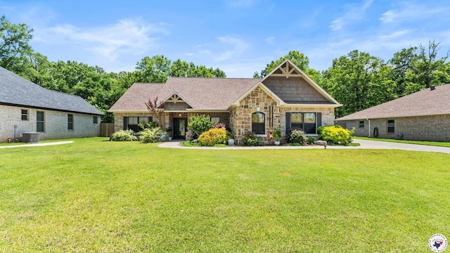 6917 Woodmere Ct, Texarkana, TX 75503 - craftsman-style house with central air condition unit, a front yard, and stone siding