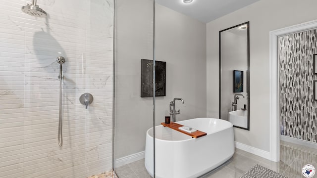 6917 Woodmere Ct, Texarkana, TX 75503 - bathroom with a freestanding tub, a tile shower, tile patterned floors, and baseboards