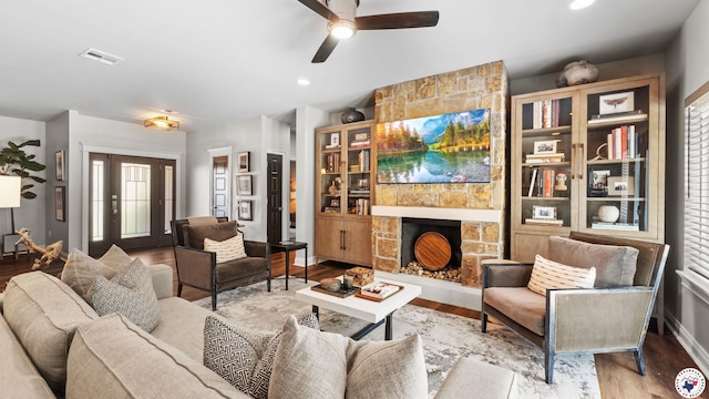 6917 Woodmere Ct, Texarkana, TX 75503 - living room featuring a ceiling fan, a fireplace, and wood finished floors