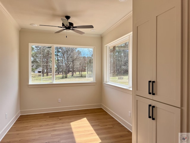 unfurnished room featuring light wood-style floors, ornamental molding, and baseboards