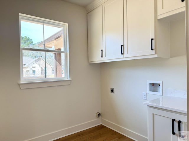 clothes washing area featuring hookup for a washing machine, cabinet space, hookup for an electric dryer, wood finished floors, and baseboards