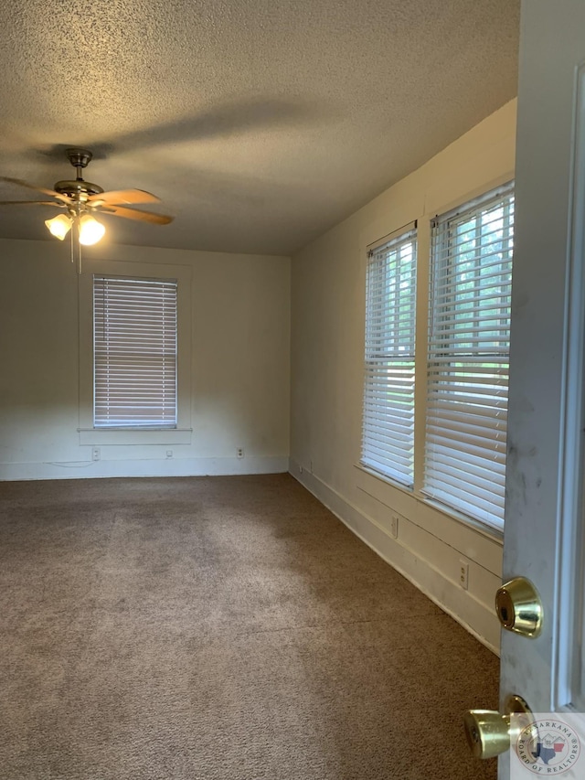 unfurnished room featuring ceiling fan, carpet, and a textured ceiling