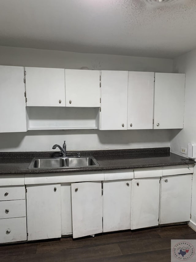 kitchen featuring sink, white cabinetry, and dark hardwood / wood-style flooring